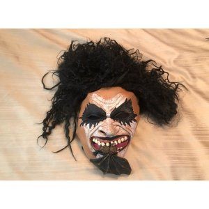 Creepy Halloween mask with bat in it’s teeth